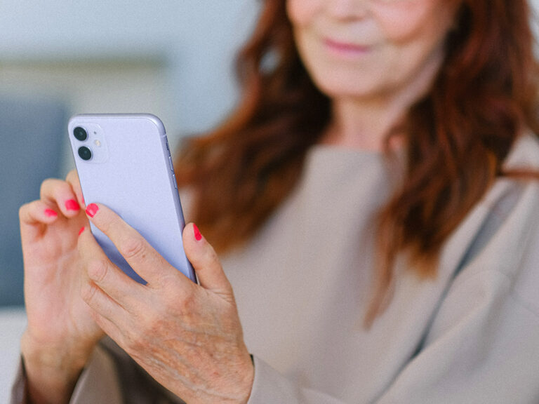 Senior Resident Using Smartphone Mobile App for Rent Payment