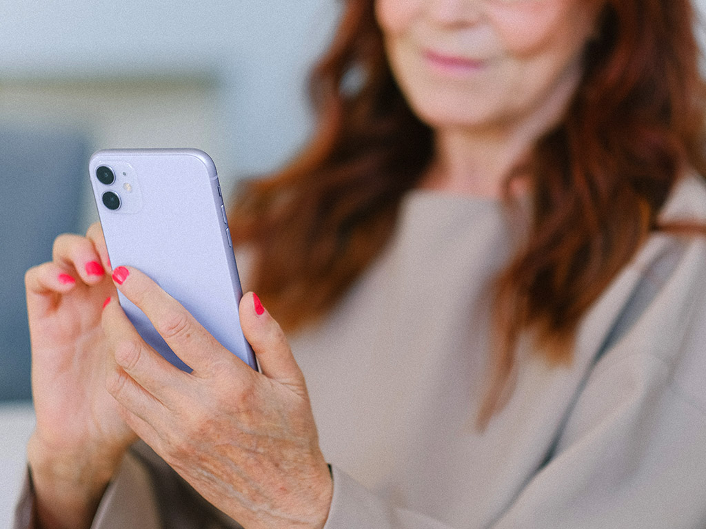 Senior Resident Using Smartphone Mobile App for Rent Payment