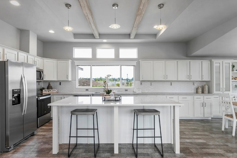 contemporary kitchen with oversized island and wood beams at lavender meadows in sequim wa