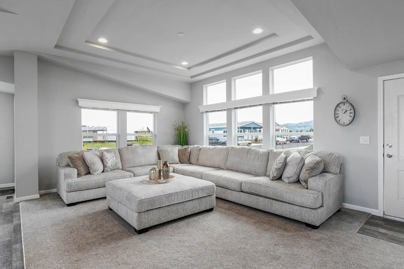 luminous living room with tray ceiling and sectional at lavender meadows in sequim wa